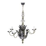 An early 20th century French patinated and polished metal and glass eight light chandelier in the...