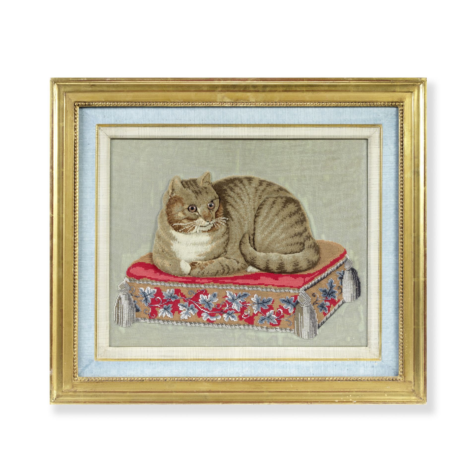 A mid 19th century chenille embroidered, wool-work and beaded picture of a tabby cat, later mount...
