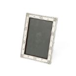 An Arts and Crafts silver photograph frame W H Haselar for Liberty, Birmingham 1913, incuse patte...