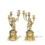 A pair of late 19th century French gilt bronze figural four light garniture candelabra in the Lo...