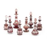 A collection of eight various Bohemian style red flashed small glass bottles and stoppers (8)