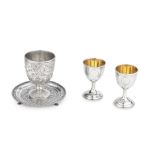 A PAIR OF GILT SILVER WINE CUPS AND A REPOUSS&#201; SILVER STEM CUP AND STAND Early 20th century (4)