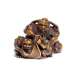 A BOXWOOD NETSUKE OF SHOKI WITH ONI (DEMONS) Attributed to Ohara Mitsuhiro (1810-1875), Osaka, Ed...