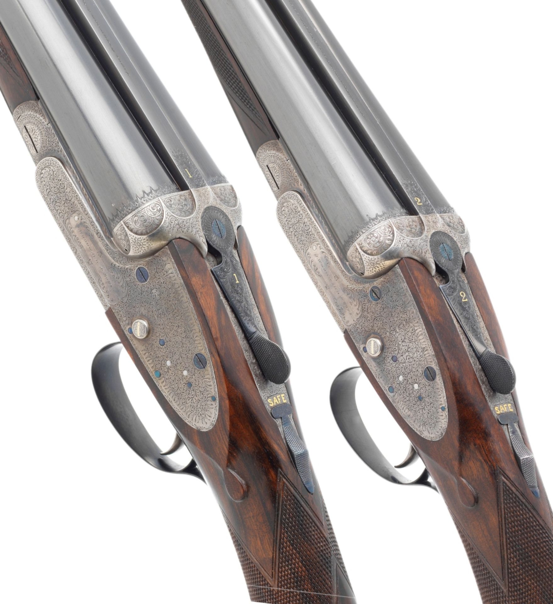 A pair of 12-bore sidelock ejector guns by James Woodward & Co., no. 5451/2 In their brass-mounte...