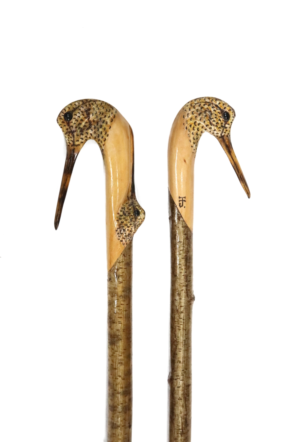 A pair of carved sporting staffs by Ian Jones