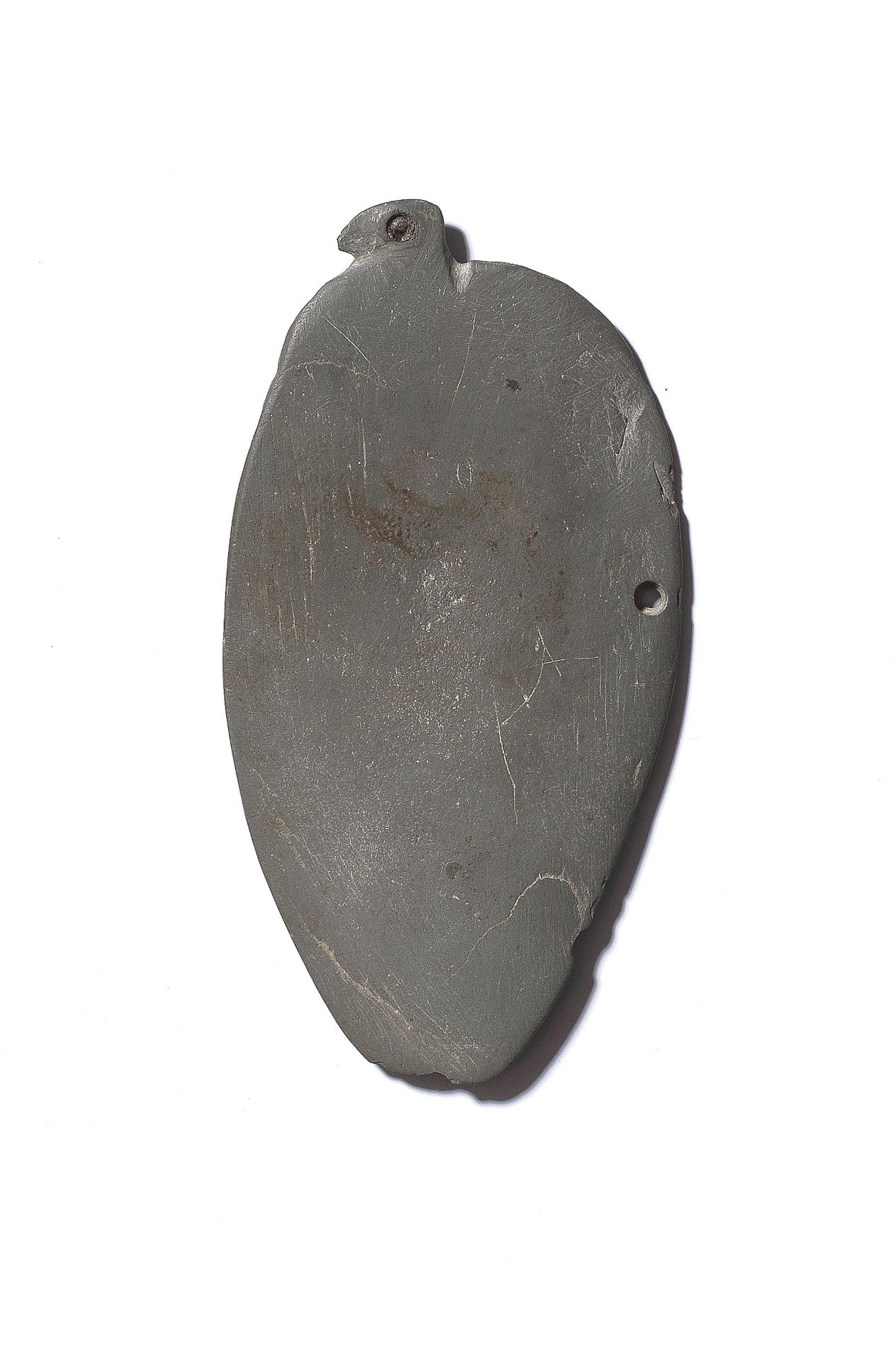 An Egyptian greywacke palette in the form of a bird