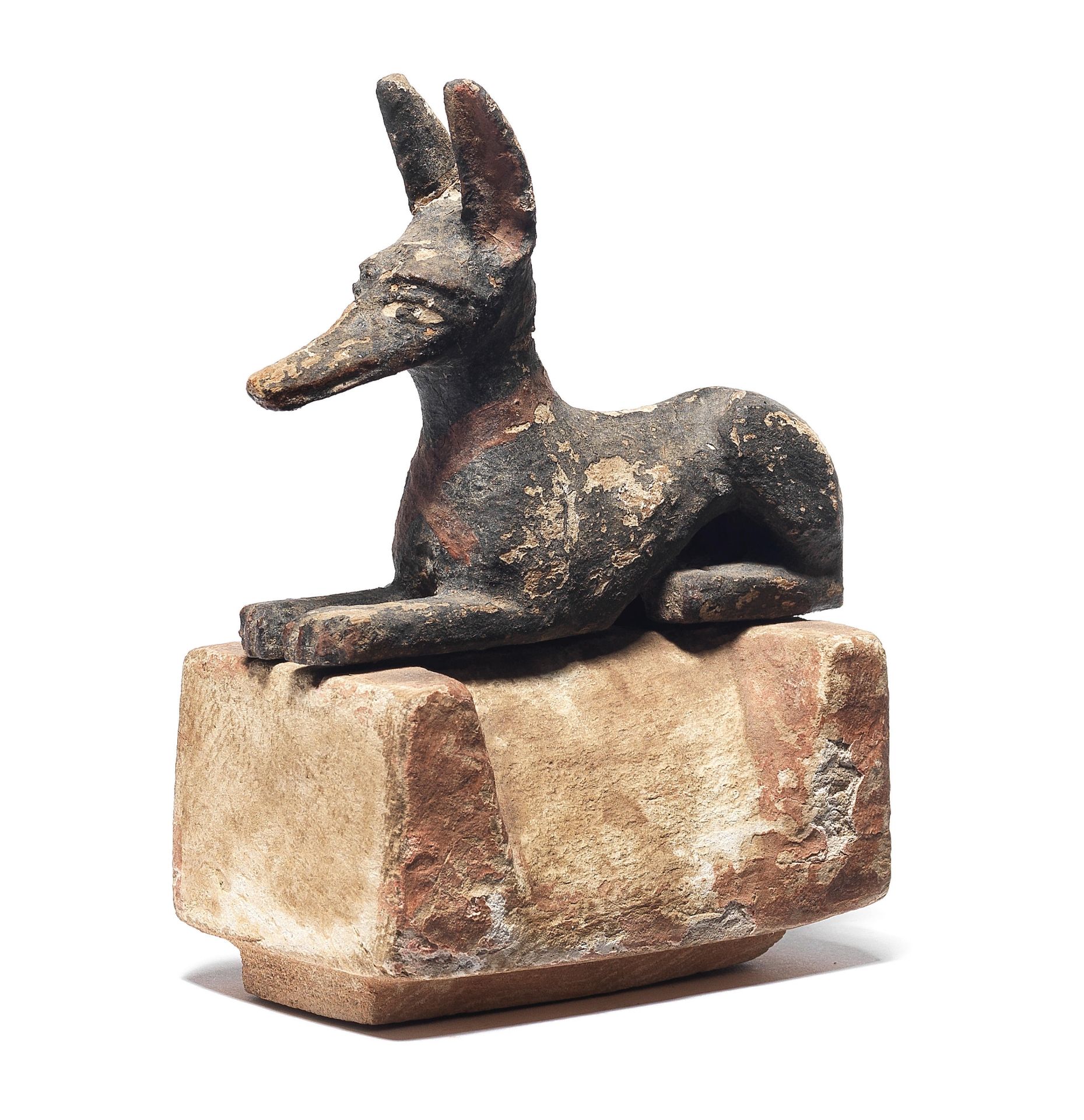 An Egyptian polychrome wood figure of a jackal