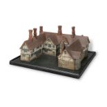 A PAINTED WOODEN SCALE MODEL OF A TUDOR HOUSEEarly 20th century