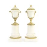 A pair of Louis XVI gilt bronze and white marble cassolettes