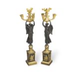 A pair of French Empire gilt and patinated bronze three branch figural candelabra circa 1810 (2)