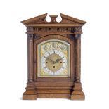 An impressive late 19th century Continental carved oak quarter chiming table clock