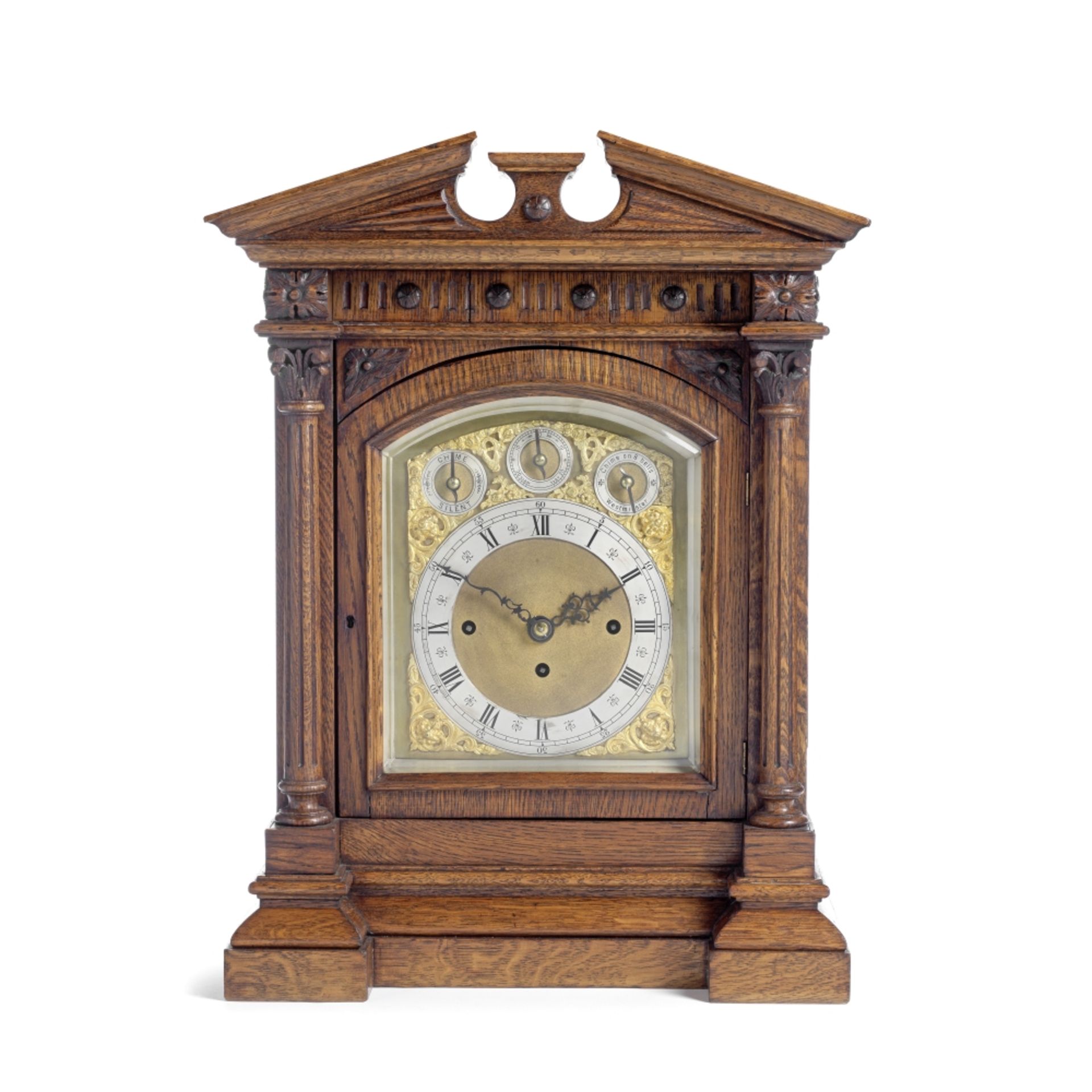 An impressive late 19th century Continental carved oak quarter chiming table clock