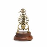 A late 19th century brass skeleton clock with passing strike together with an associated modern g...