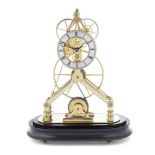 A modern brass skeleton timepiece with glass dome and stained wood oval base