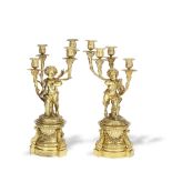 A pair of late 19th century French gilt bronze figural four light garniture candelabra in the Lo...