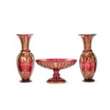 A pair of large and decorative Continental ruby cut and gilded glass vases together with a simila...