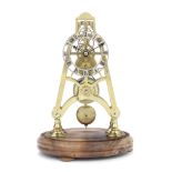 A late 19th / early 20th century brass skeleton timepiece together with an associated modern glas...
