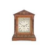 A good late 19th/early 20th century carved oak table clock the dial signed J. Smith & Sons, Clerk...