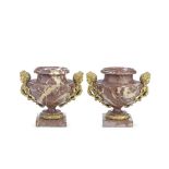 A pair of late 19th/early 20th century French gilt bronze mounted rouge marble pedestal garniture...