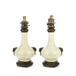 A pair of Chinese porcelain Ge-type bottle vases mounted as oil lamp bases, the porcelain and Fr...
