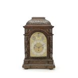 An impressive late 19th century German carved oak quarter chiming table clock the movement numbe...