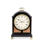 An early 19th century ebonised single pad top table clock the dial signed Paul, London, the move...