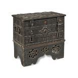 A German 17th century cast-iron strong box on a later ebonised stand the stand apparently 19th ce...