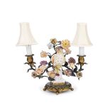 A late 19th/early 20th century gilt and patinated metal mounted porcelain candelabra the porcelai...