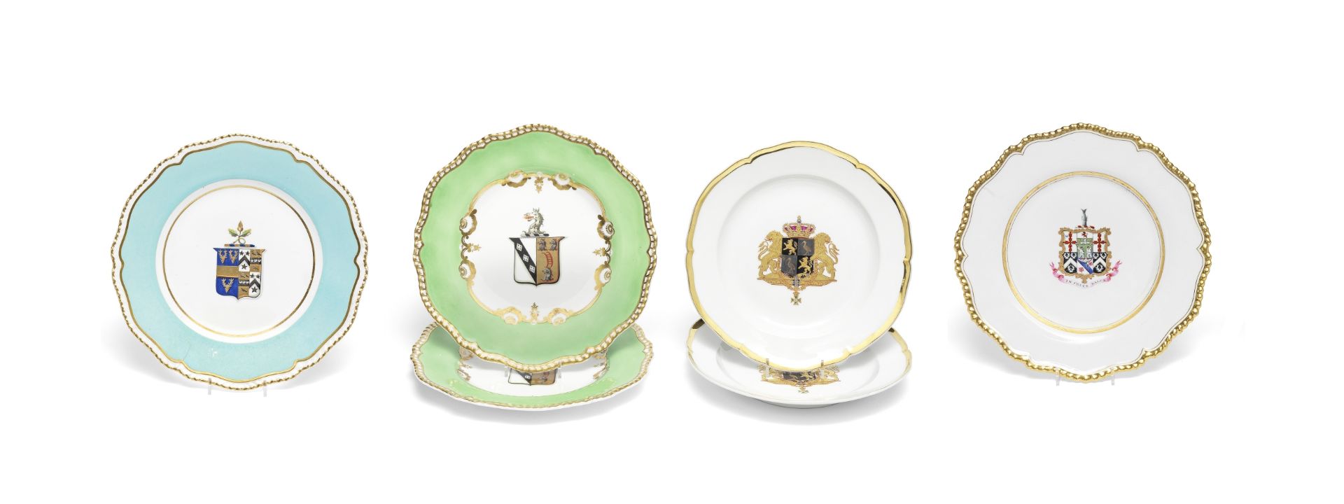 Four English porcelain armorial plates together with a pair of Berlin K.P.M hexafoil armorial pla...