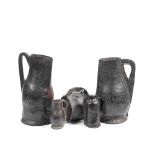 Two large leather bombards, together with a small bombard, a lidded drinking vessel, and a costre...