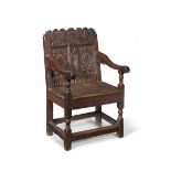 A carved oak panel back armchair Late 17th century, Cheshire/Lancashire