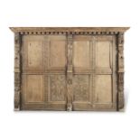 An 18th century and later carved oak bed headboard