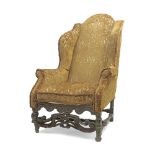 A late 17th century oak framed wingback armchair