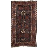 A Kurdish rug West Persia 289cm long x 163cm wide (113 1/3in long x 64in wide)