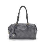 Bottega Veneta: a Black Intrecciato Montaigne Bag (includes padlock, keys, cloche, mirror and dus...