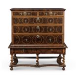 A late 17th century walnut, fruitwood and oyster veneered chest on stand