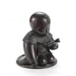 A bronze incense burner cover in the shape of a kneeling boy China, Qing Dynasty