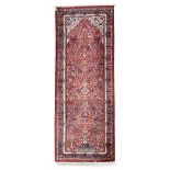 A North West Persian runner 323cm x 123cm (127in x 48 1/2in)