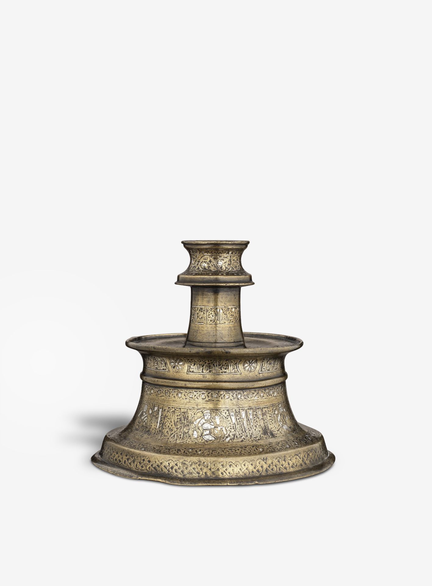 A silver inlaid bronze candlestick Persia, 13th/ 14th Century