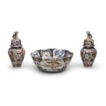 A LARGE PORCELAIN PUNCH BOWL AND TWO COVERED BALUSTER VASES Imari ware, Edo period (1615-1868), e...