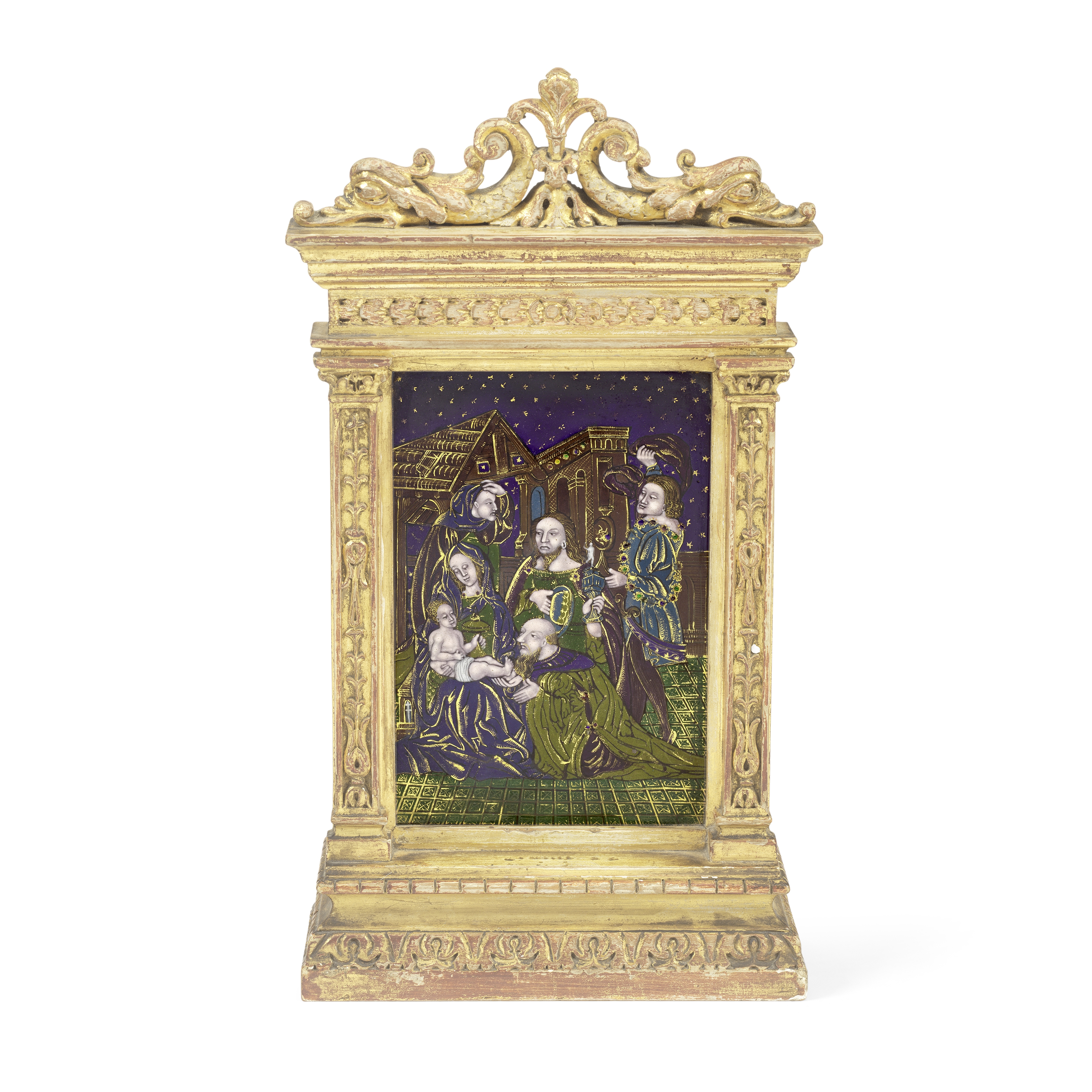 A Limoges style enamel plaque depicting the Adoration of the Magi mounted within a carved and gil...