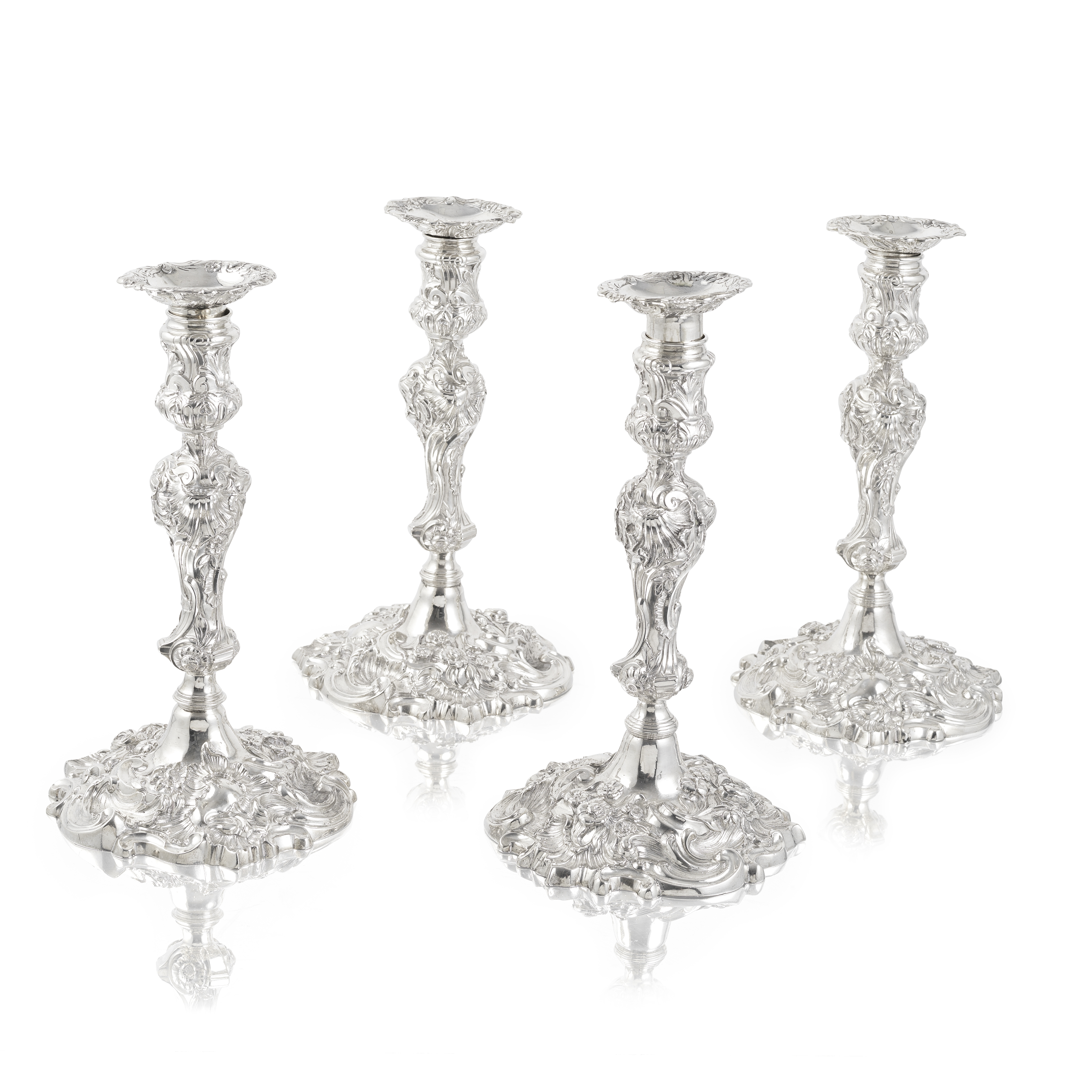A set of four George II cast silver candlesticks John Cafe, one London 1745 - two 1746, one with...