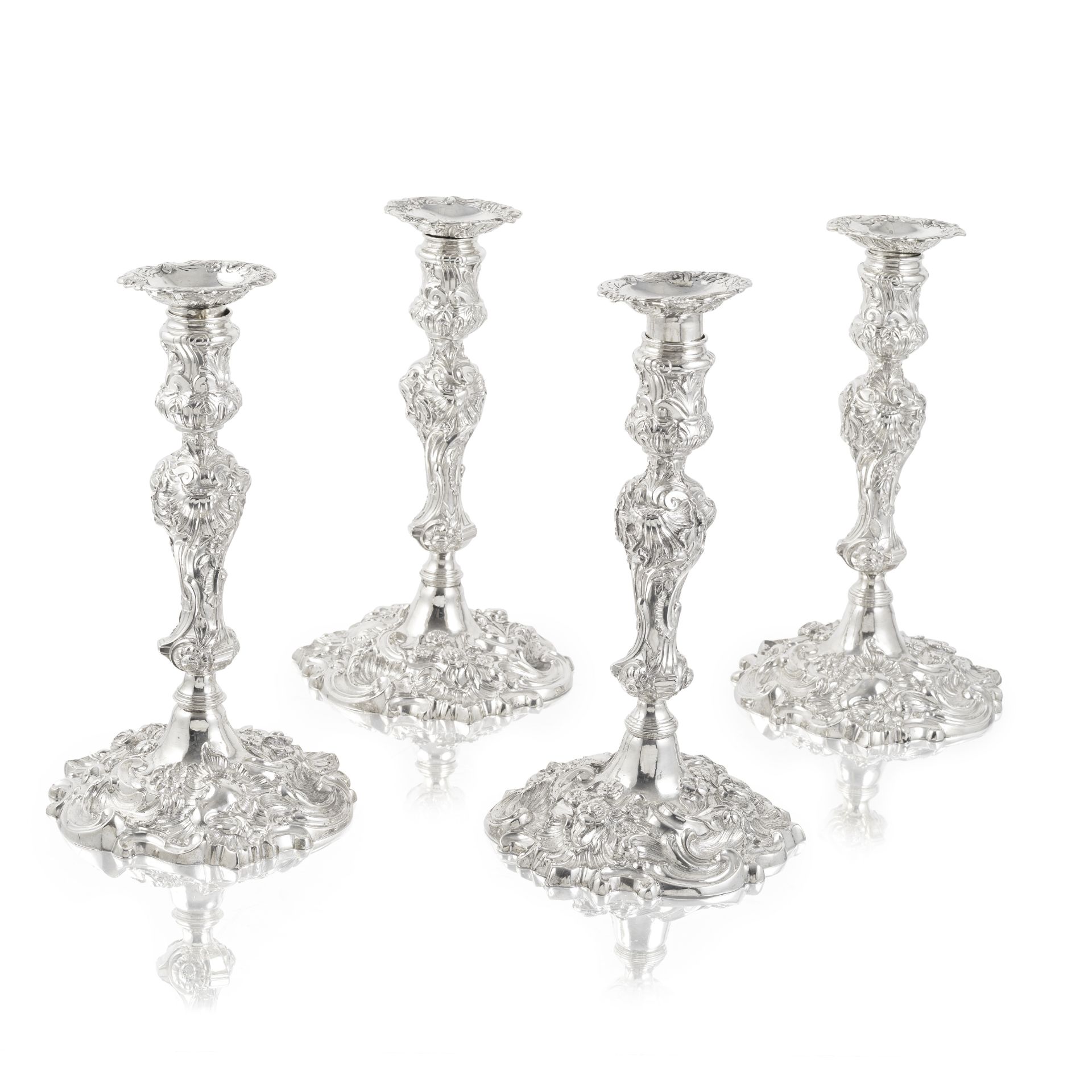 A set of four George II cast silver candlesticks John Cafe, one London 1745 - two 1746, one with...