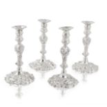 A set of four George II cast silver candlesticks John Cafe, one London 1745 - two 1746, one with...