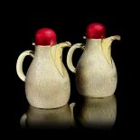 GERALD BENNEY: a rare pair of silver-gilt and enamelled pitchers London 1973, the bases with mast...