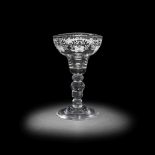 A very rare engraved acorn-knopped baluster sweetmeat or 'lemon' glass, circa 1730-40