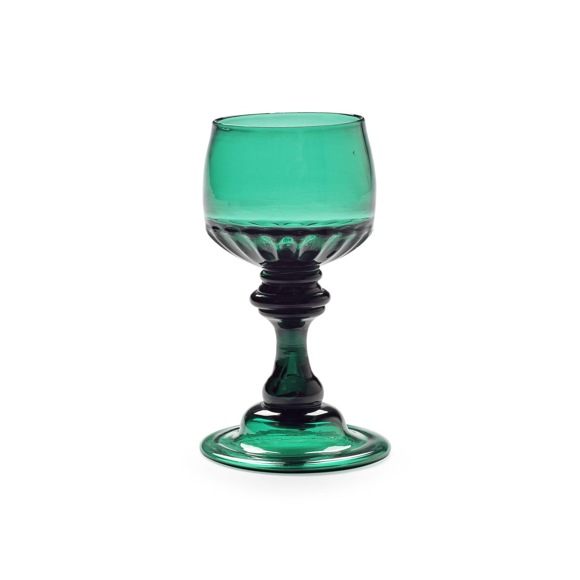 A rare emerald-green baluster mead or champagne glass, circa 1740-60
