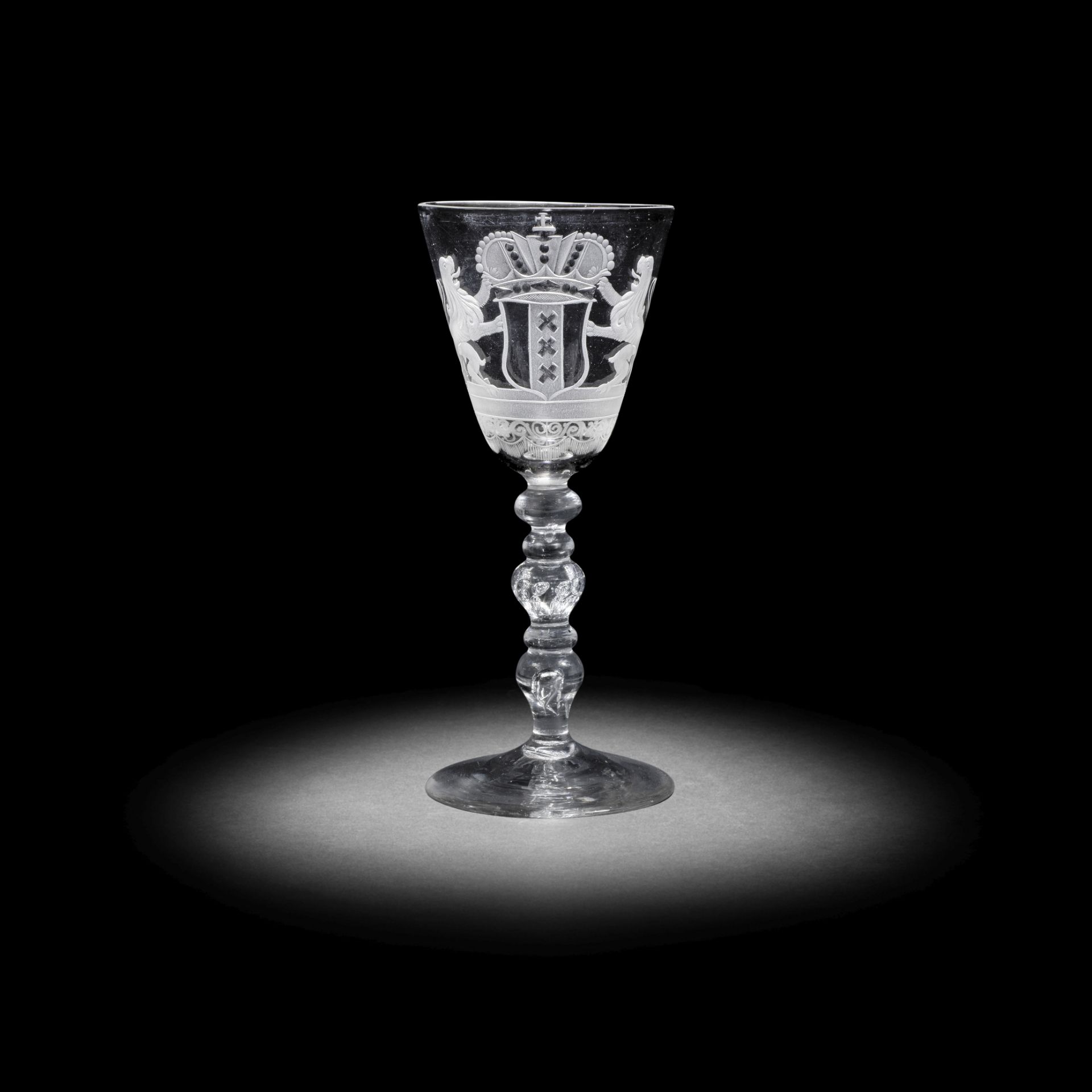 A Dutch engraved armorial light baluster wine glass, circa 1750