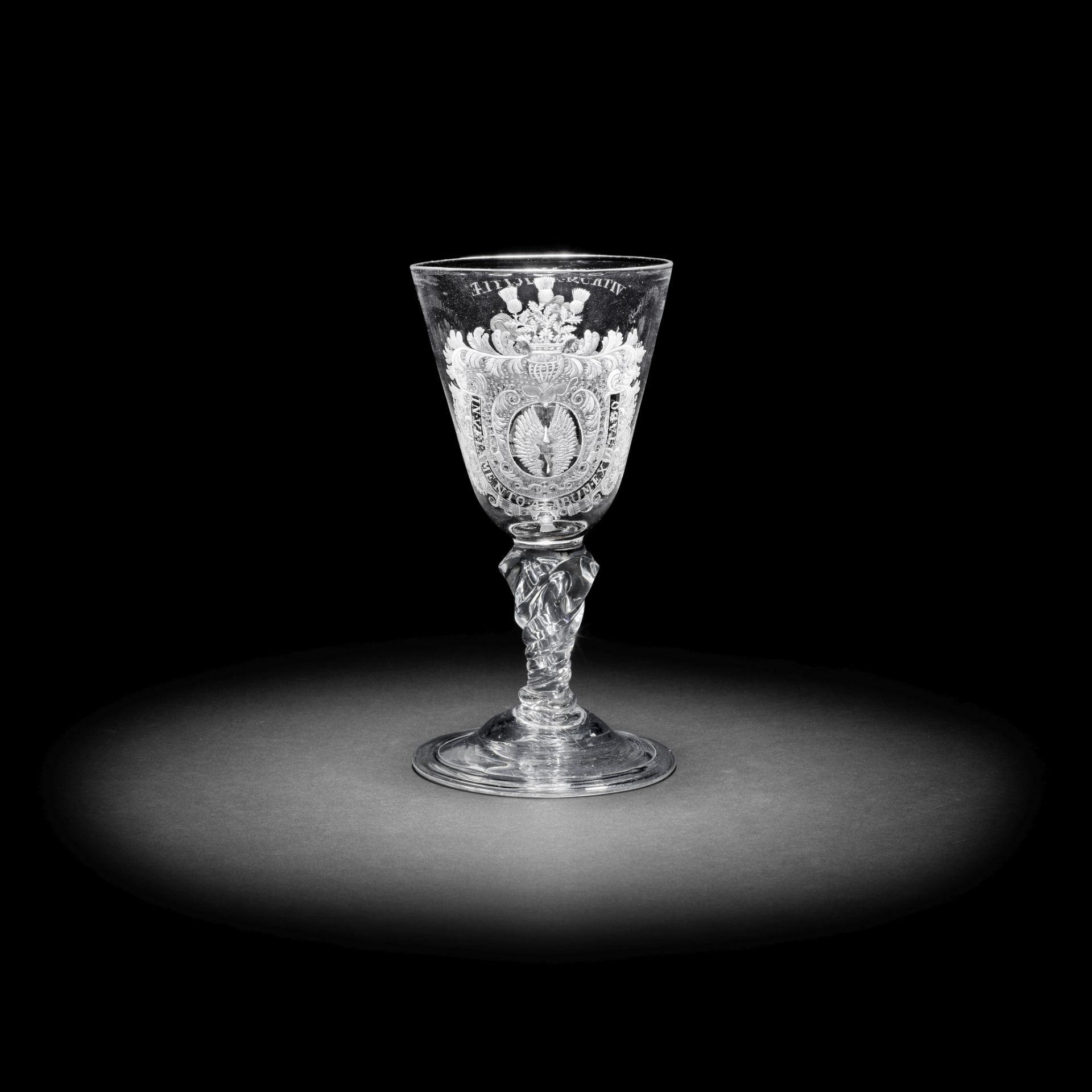 An exceptionally rare Dutch engraved armorial moulded-stem 'Friendship' goblet, circa 1720-30