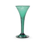 An exceptional emerald-green engraved airtwist wine glass, circa 1750